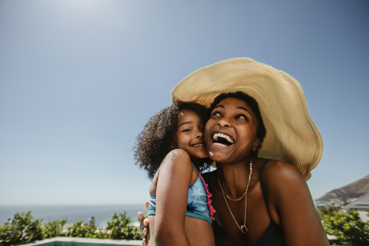 An image of a woman and a child having fun on a tropcial beach, knowing they're protected by travel insurance